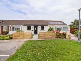 A house with a front door, windows, and garden at 4 Willow Grove - Freehold in Talacre