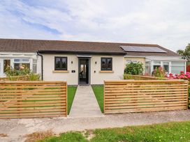 A house with a pathway and garden at 4 Willow Grove in Talacre
