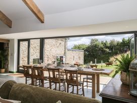 A dining room with a table set for meals at Reddaway Threshing Barn near Okehampton