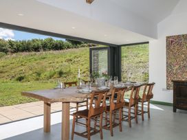 A dining room with a large table and chairs at Reddaway Threshing Barn near Okehampton