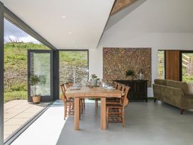 A dining room with a table and chairs at Reddaway Threshing Barn near Okehampton