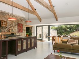 A kitchen with a dining area and large windows at Reddaway Threshing Barn near Okehampton