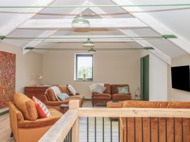 A living room with sofas and artwork at Reddaway Threshing Barn near Okehampton