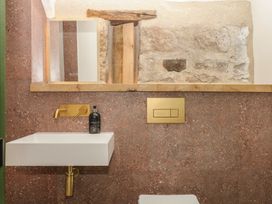 A bathroom with a sink and mirror at Reddaway Threshing Barn near Okehampton