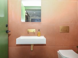 A bathroom with a sink and mirror at Reddaway Threshing Barn near Okehampton