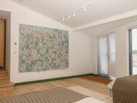 A bedroom with an artwork on the wall at Reddaway Threshing Barn near Okehampton