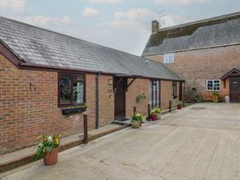 An outdoor area with brick building and planters at Daisy Cottage Whitchurch Canonicorum near Charmouth