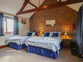A bedroom with two beds and a window at Daisy Cottage in Whitchurch Canonicorum near Charmouth
