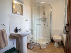 A bathroom with a shower, toilet, and sink at Daisy Cottage Whitchurch Canonicorum near Charmouth