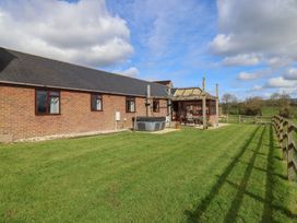 A garden with a hot tub and fence at Daisy Cottage Whitchurch Canonicorum near Charmouth