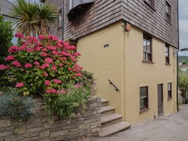 A house exterior with flowering plants and steps at Flat 2 The Cedars in Lyme Regis