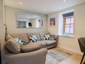 A living room with a sofa and window at Flat 2 The Cedars in Lyme Regis