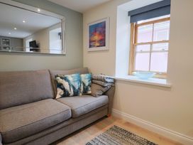 A living room with a sofa and window at Flat 2 The Cedars in Lyme Regis