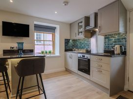 A kitchen with a stove and sink at Flat 2 The Cedars in Lyme Regis