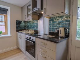 A kitchen with cabinets and appliances at Flat 2 The Cedars Lyme Regis