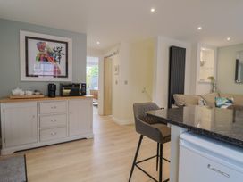 A kitchen with a coffee maker and artwork on the wall at Flat 2 The Cedars Lyme Regis