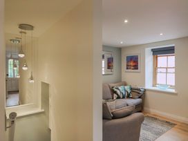 A living room with a sofa and a window at Flat 2 The Cedars in Lyme Regis