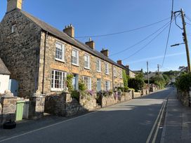 A row of stone houses with flowers in the front yard at Ty Clyd in Newport, Pembrokeshire