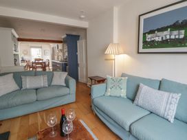 A living room with sofas and a dining area at Ty Clyd Newport, Pembrokeshire