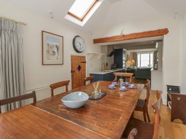 A dining room with a wooden table and chairs at Ty Clyd in Newport, Pembrokeshire