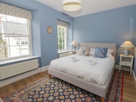 A bedroom with a bed and windows at Ty Clyd in Newport, Pembrokeshire