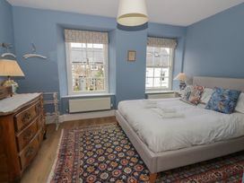 A bedroom with a bed and a dressing table at Ty Clyd in Newport, Pembrokeshire