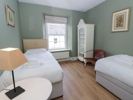 A bedroom with two beds and a window at Ty Clyd in Newport, Pembrokeshire