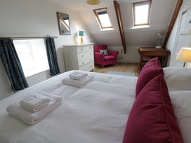 A bedroom with a bed and desk at Ty Clyd in Newport, Pembrokeshire