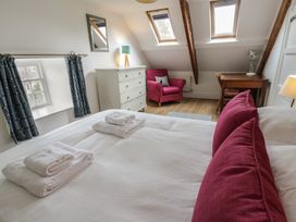 A bedroom with a bed and dresser at Ty Clyd in Newport, Pembrokeshire