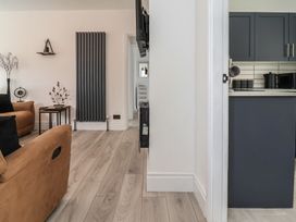A living room with a sofa and table at Driftwood in Rhyl