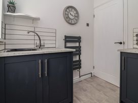 A kitchen with a sink and countertops at Driftwood in Rhyl
