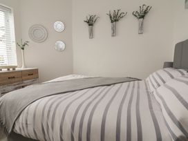 A bedroom with a bed and decorative elements at Driftwood in Rhyl