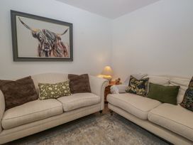 A living room with sofas and artwork at Highfield Cottage in Windermere