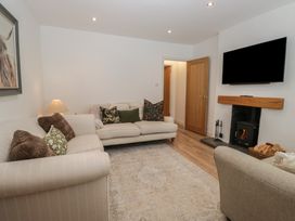 A living room with a sofa and fireplace at Highfield Cottage in Windermere