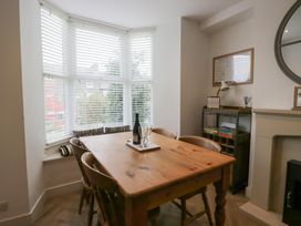 A dining room with a table and chairs at Highfield Cottage in Windermere