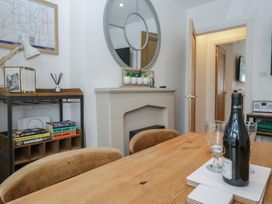 A dining room with a table and chairs at Highfield Cottage in Windermere