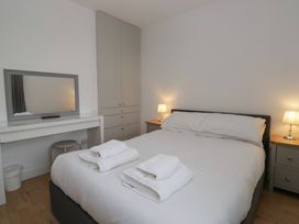 A bedroom with a bed and desk at Highfield Cottage in Windermere