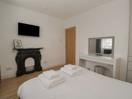 A bedroom with a bed and towels on it at Highfield Cottage in Windermere