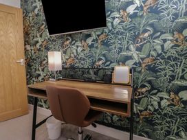 An office with a desk and lamp at Highfield Cottage in Windermere