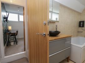 A bathroom with a sink and a bathtub at Highfield Cottage in Windermere