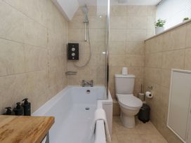 A bathroom with a shower and bathtub at Highfield Cottage in Windermere
