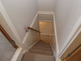 A staircase with a handrail at Highfield Cottage in Windermere