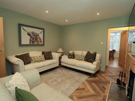 A living room with sofas and a rug at Highfield Cottage in Windermere