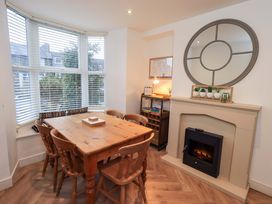 A dining room with a table and chairs at Highfield Cottage in Windermere