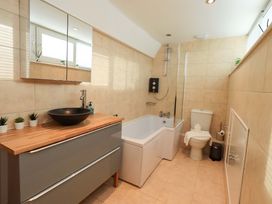 A bathroom with a sink and bathtub at Highfield Cottage in Windermere