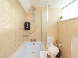 A bathroom with a bathtub and shower at Highfield Cottage in Windermere
