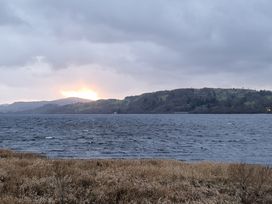 A lake with hills in the background and cloudy sky at Old Ty'n Y Wern in Rhosygwalia near Bala