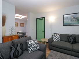 A living room with sofas and a table at Havelock Hideaway in Windermere