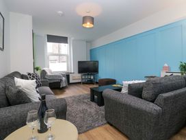 A living room with sofa and television at Havelock Hideaway in Windermere