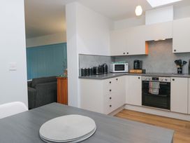 A kitchen with appliances and furniture at Havelock Hideaway in Windermere